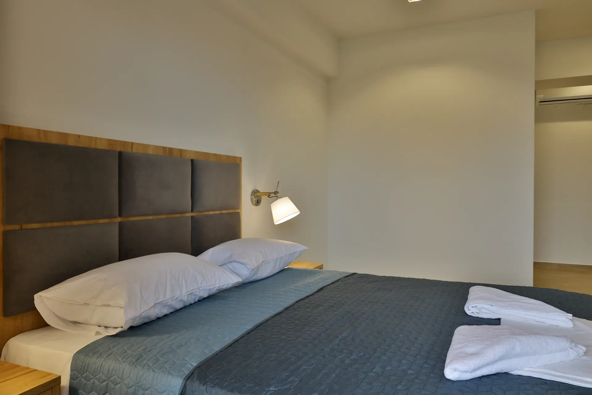 Large double bed with a padded headboard
