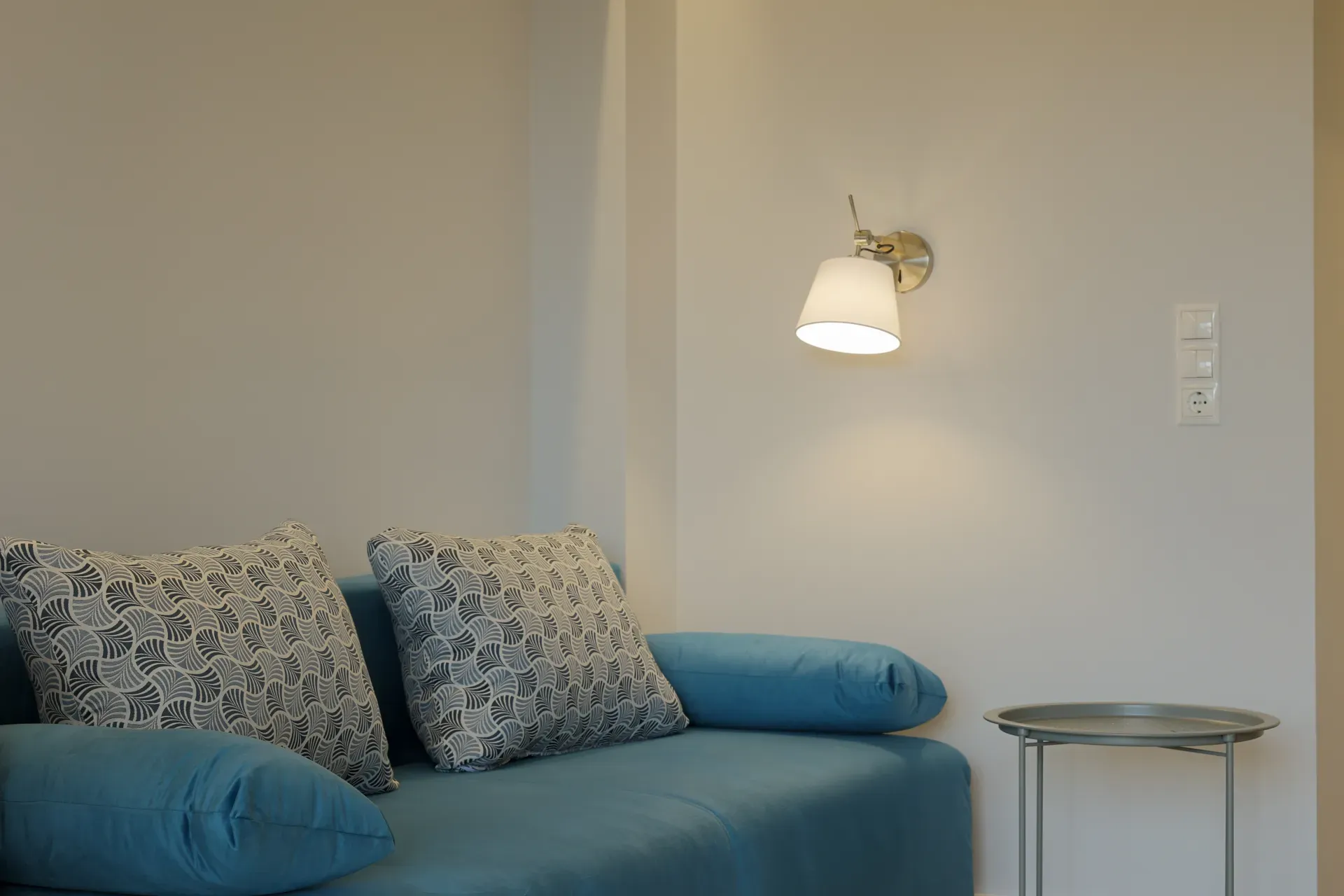 Turquoise sofa bed with decorative cushions
